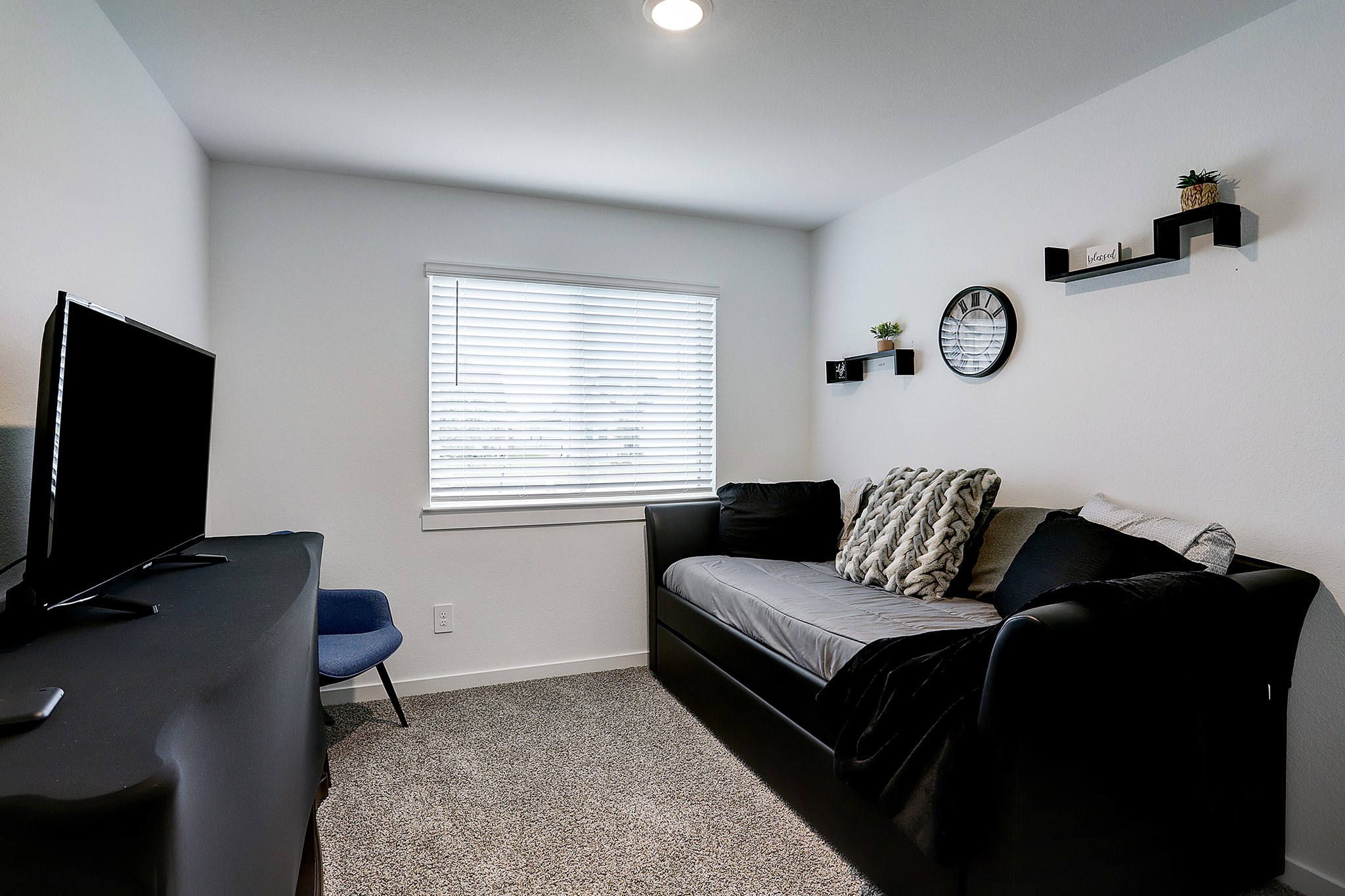 3838 Beltingham Bend Way Fulshear, TX 77441 - Photo 14 of 22 a living room with furniture and a flat screen tv