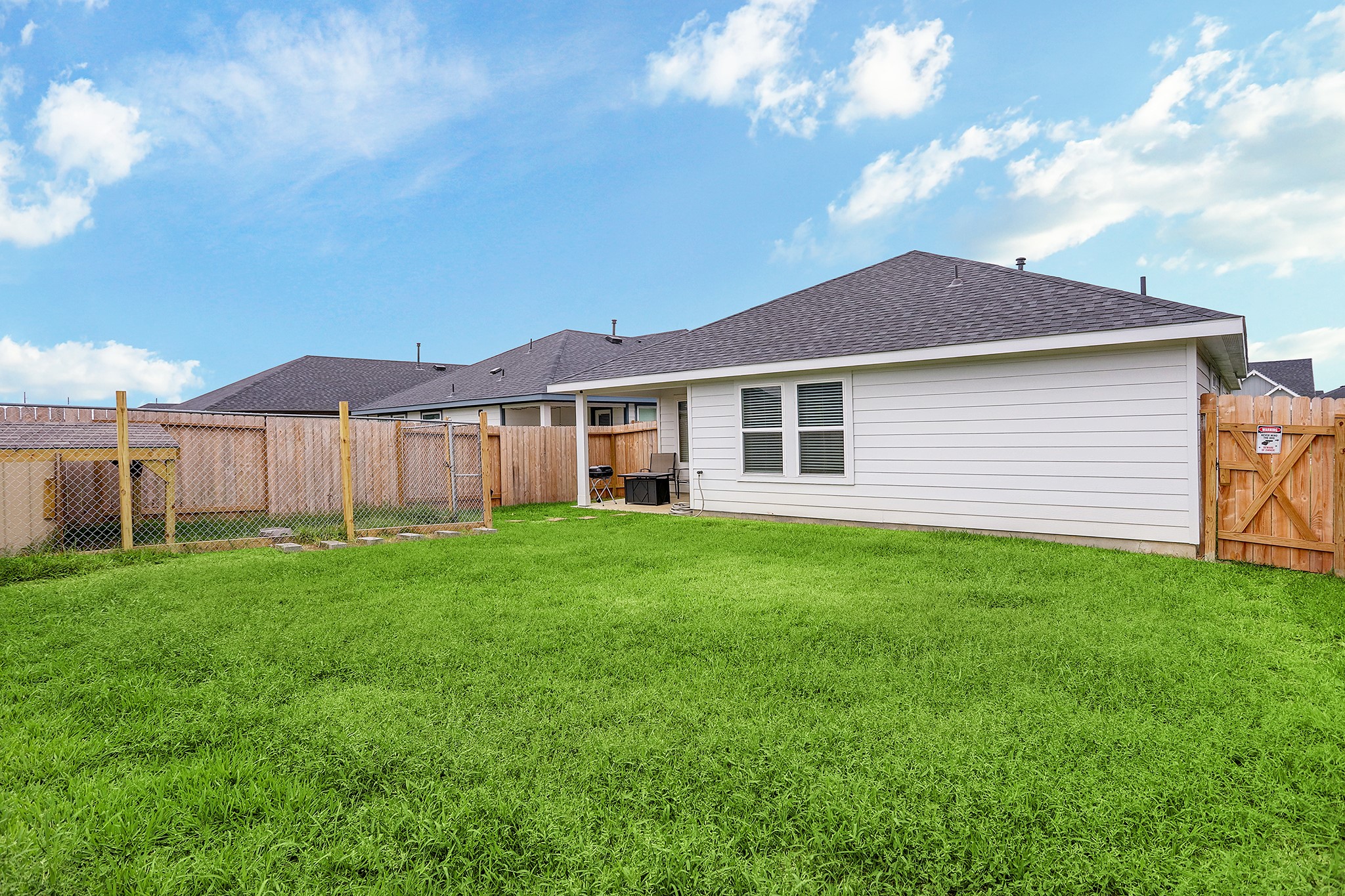 3838 Beltingham Bend Way Fulshear, TX 77441 - Photo 17 of 22 a view of a yard in front of a house with large tree