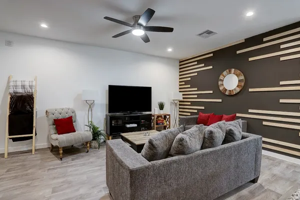 a living room with furniture and a flat screen tv