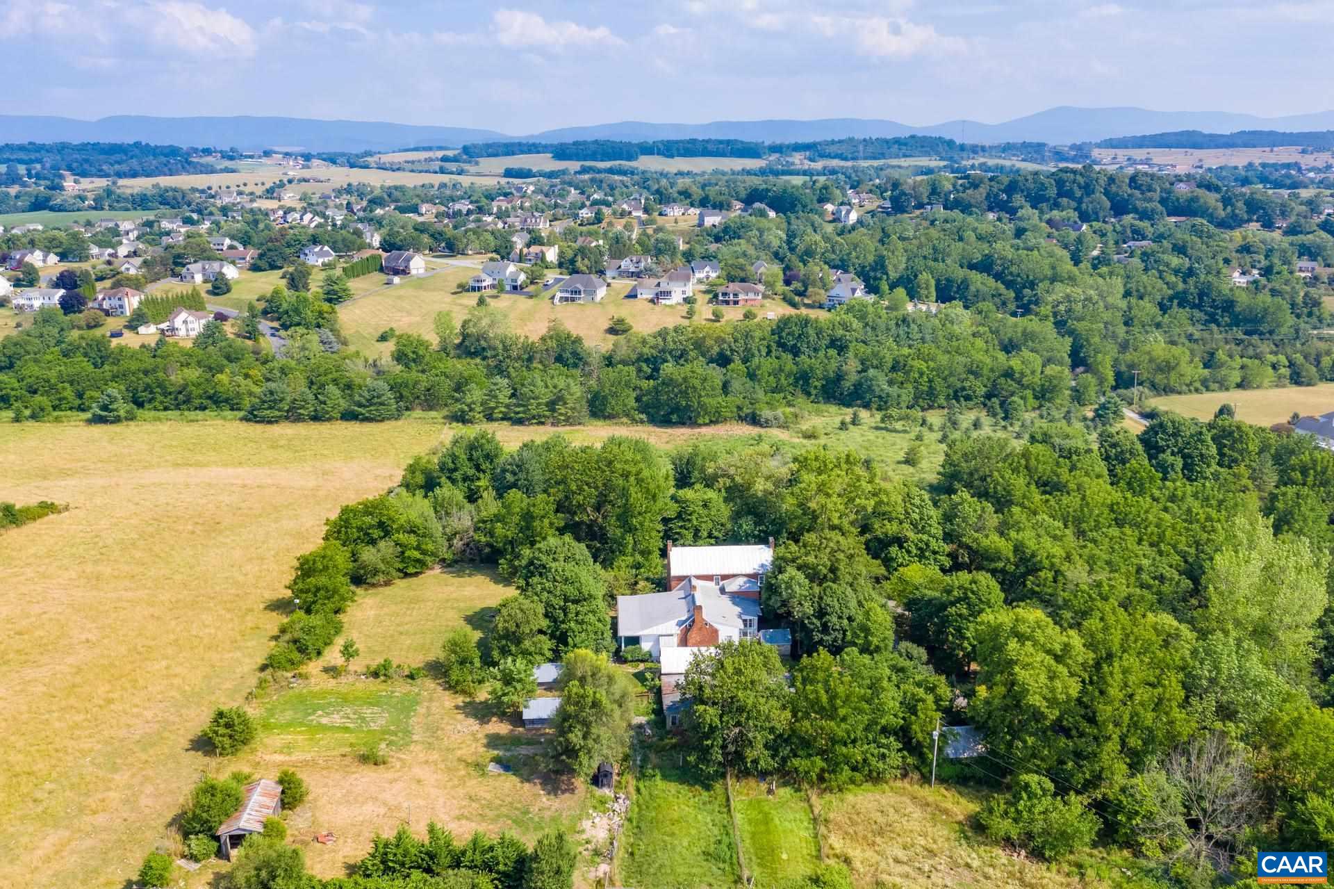 464 Long Meadow Road Fishersville, VA 22939 - Photo 59 of 62 an aerial view of green landscape with trees houses and lake view