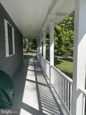 a view of a porch with wooden floor and outdoor space