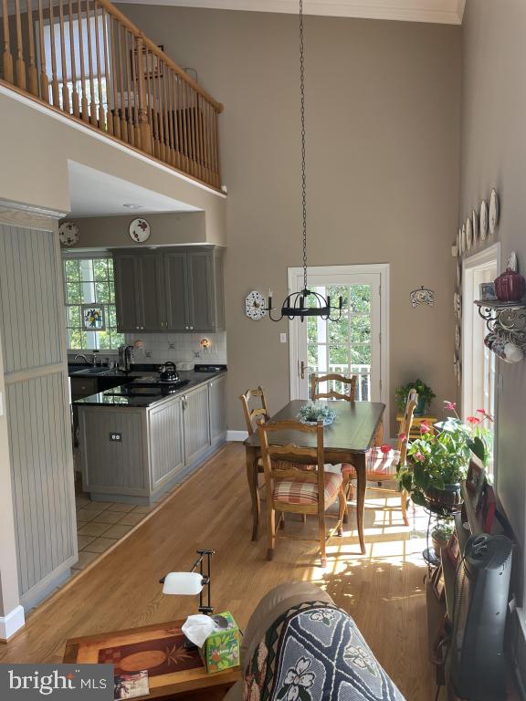 5597 Sedwick Court Frederick, MD 21702 - Photo 22 of 66 a kitchen with stainless steel appliances kitchen island granite countertop a stove a refrigerator and a dining table with wooden floor