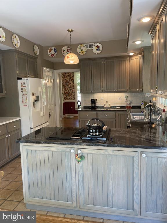 5597 Sedwick Court Frederick, MD 21702 - Photo 28 of 66 a kitchen with stainless steel appliances granite countertop a sink a stove a refrigerator a center island and cabinets