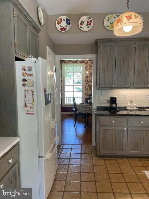 5597 Sedwick Court Frederick, MD 21702 - Photo 29 of 66 a kitchen with granite countertop a refrigerator and a stove top oven