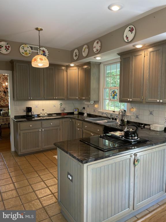 5597 Sedwick Court Frederick, MD 21702 - Photo 30 of 66 a kitchen with granite countertop a sink a counter top space and cabinets