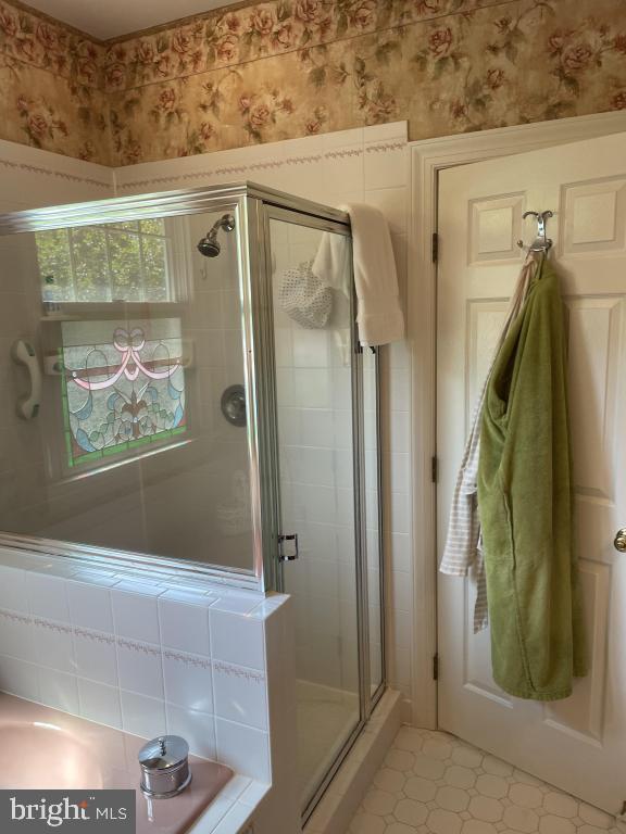 5597 Sedwick Court Frederick, MD 21702 - Photo 42 of 66 a bathroom with a shower and a mirror