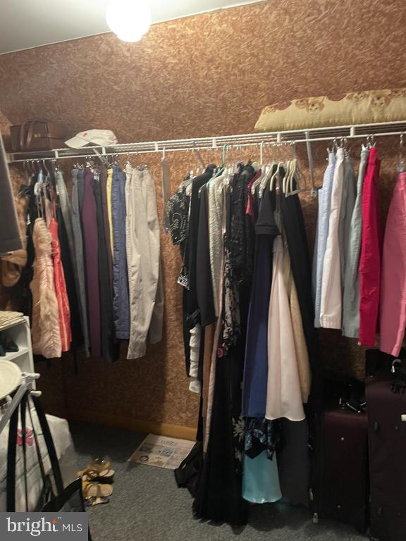 5597 Sedwick Court Frederick, MD 21702 - Photo 58 of 66 a view of walk in closet with clothes and shoes