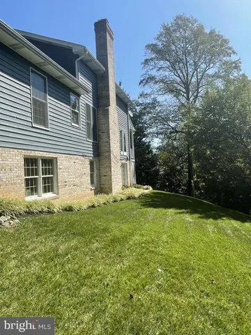 a view of yard with swimming pool and green space