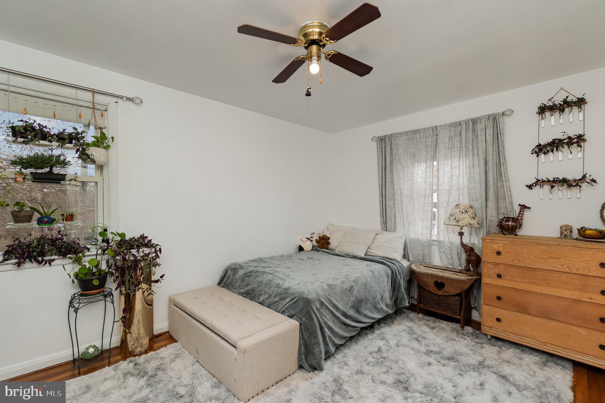 1406 Shefford Road Baltimore, MD 21239 - Photo 19 of 33 a bedroom with a bed and ceiling fan