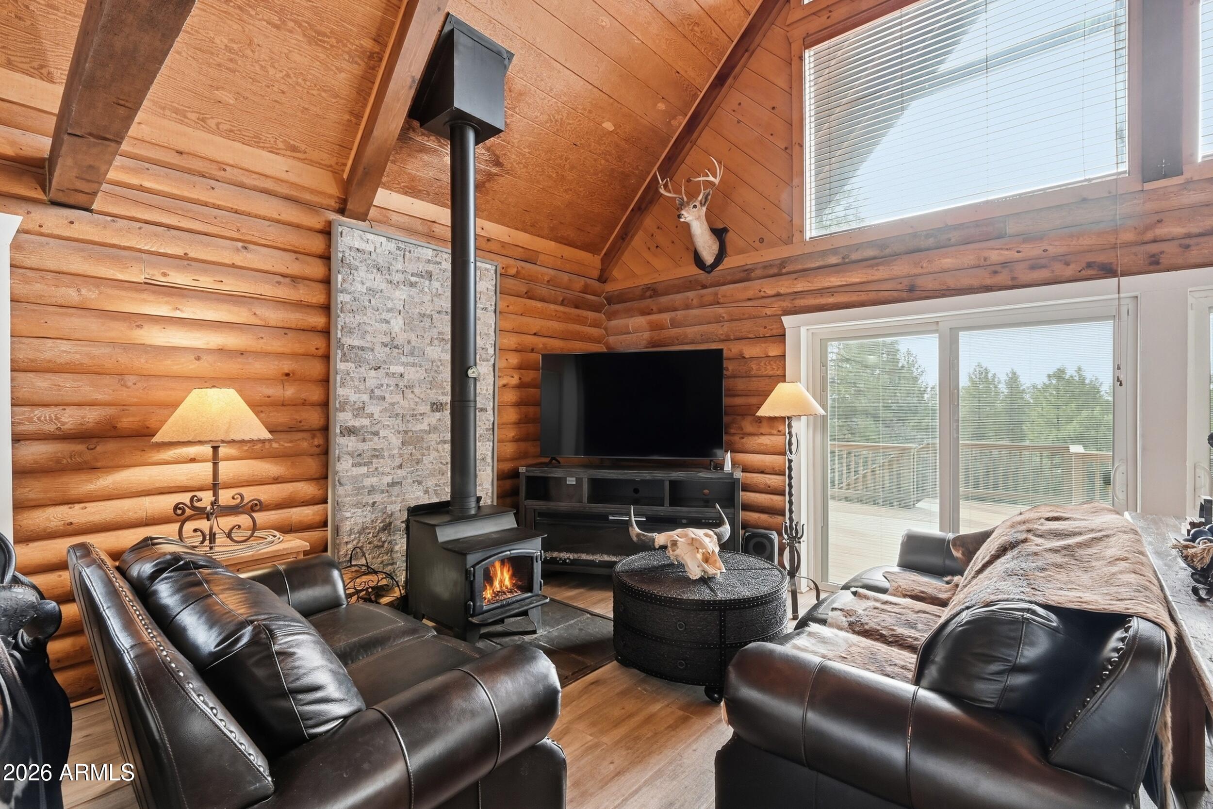 228 East Belluzzi Boulevard Payson, AZ 85541 - Photo 14 of 53 a living room with furniture a flat screen tv and a floor to ceiling window