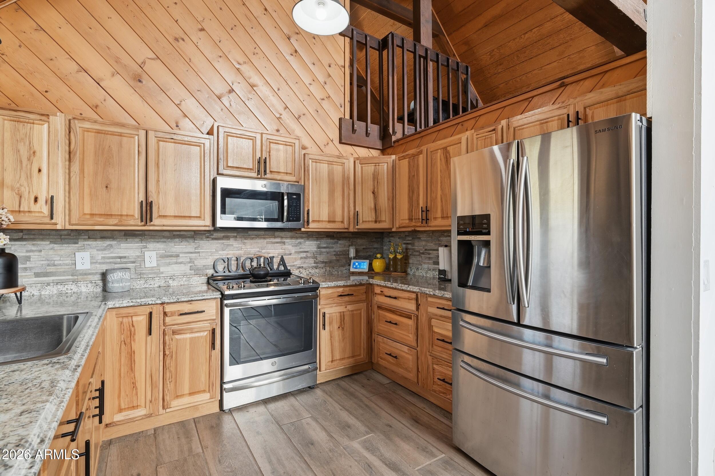 228 East Belluzzi Boulevard Payson, AZ 85541 - Photo 17 of 53 a kitchen with stainless steel appliances granite countertop a refrigerator a stove top oven a sink and dishwasher