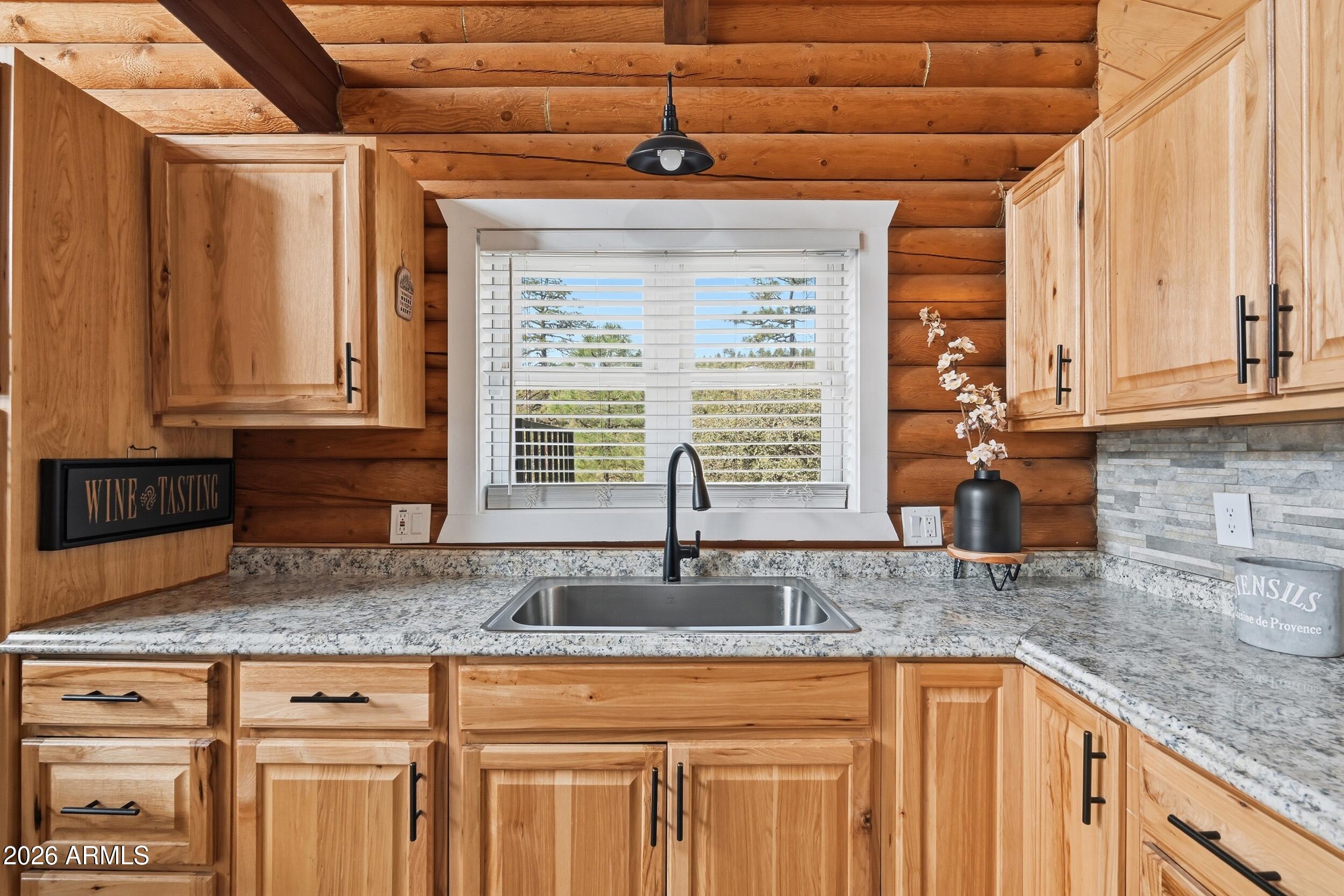 228 East Belluzzi Boulevard Payson, AZ 85541 - Photo 19 of 53 a kitchen with granite countertop a sink and wooden cabinets