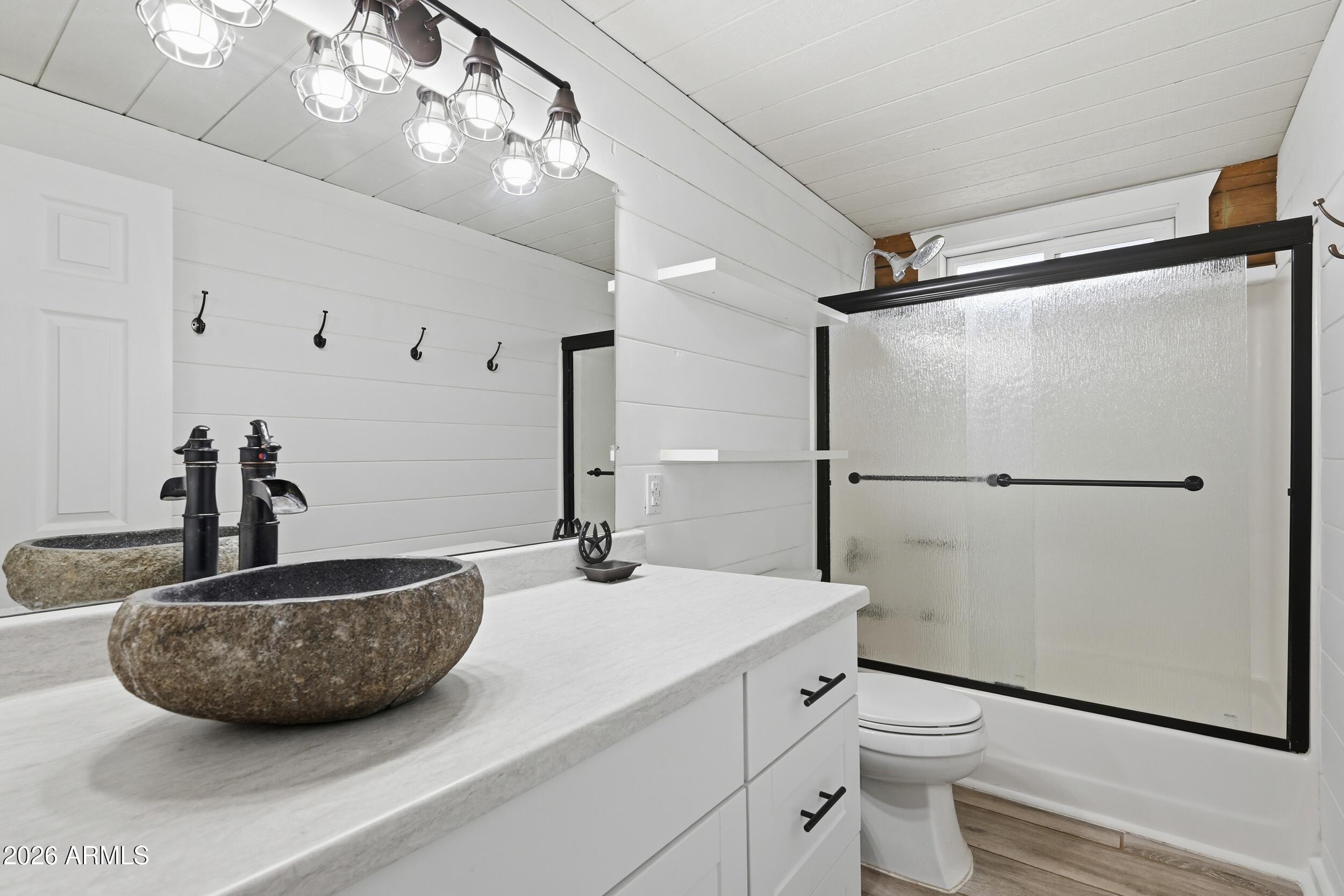 228 East Belluzzi Boulevard Payson, AZ 85541 - Photo 23 of 53 a bathroom with a sink a toilet a mirror and shower