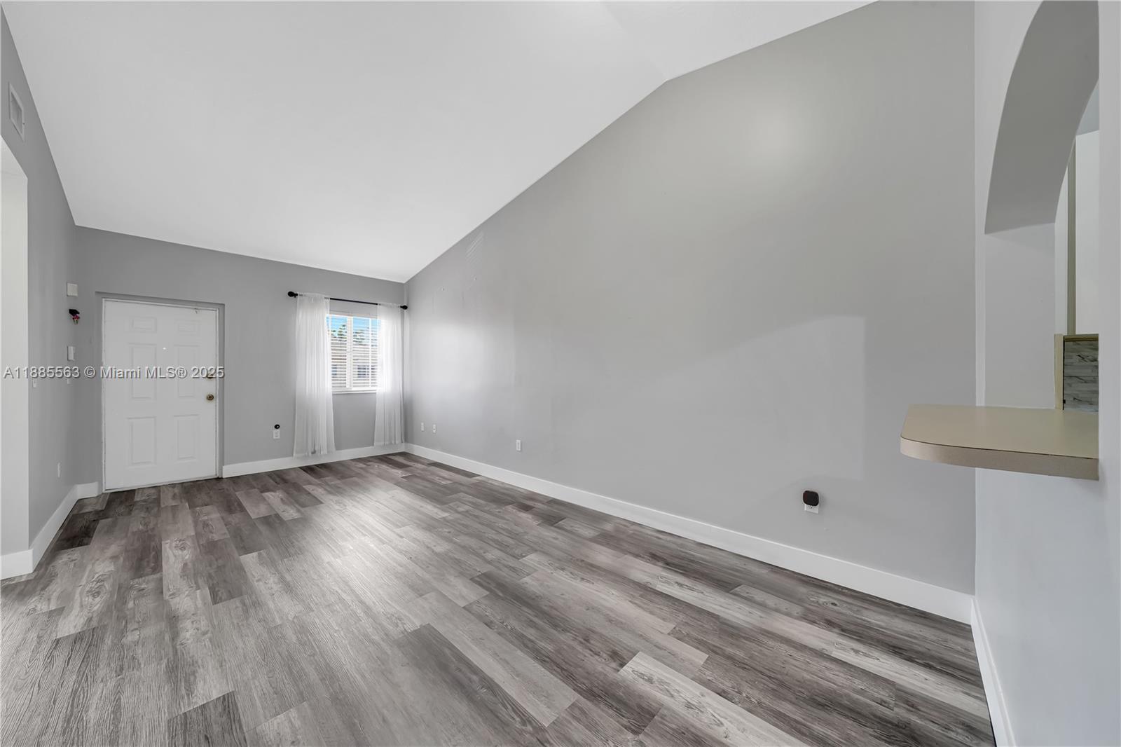 1261 Southeast 27th Street, Unit 203 Homestead, FL 33035 - Photo 7 of 18 a view of empty room with wooden floor and fan