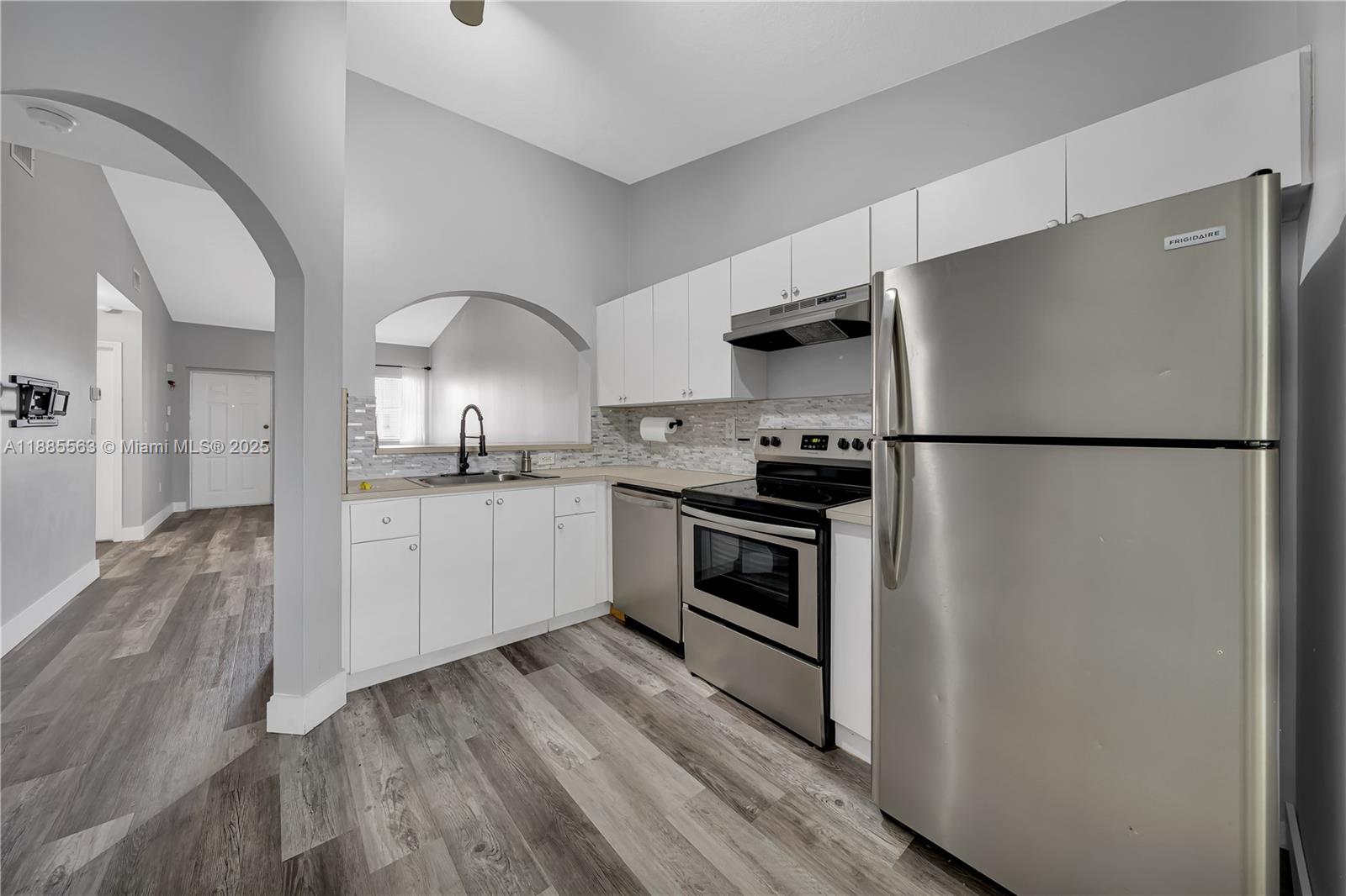 1261 Southeast 27th Street, Unit 203 Homestead, FL 33035 - Photo 9 of 18 a kitchen with stainless steel appliances a refrigerator sink and cabinets