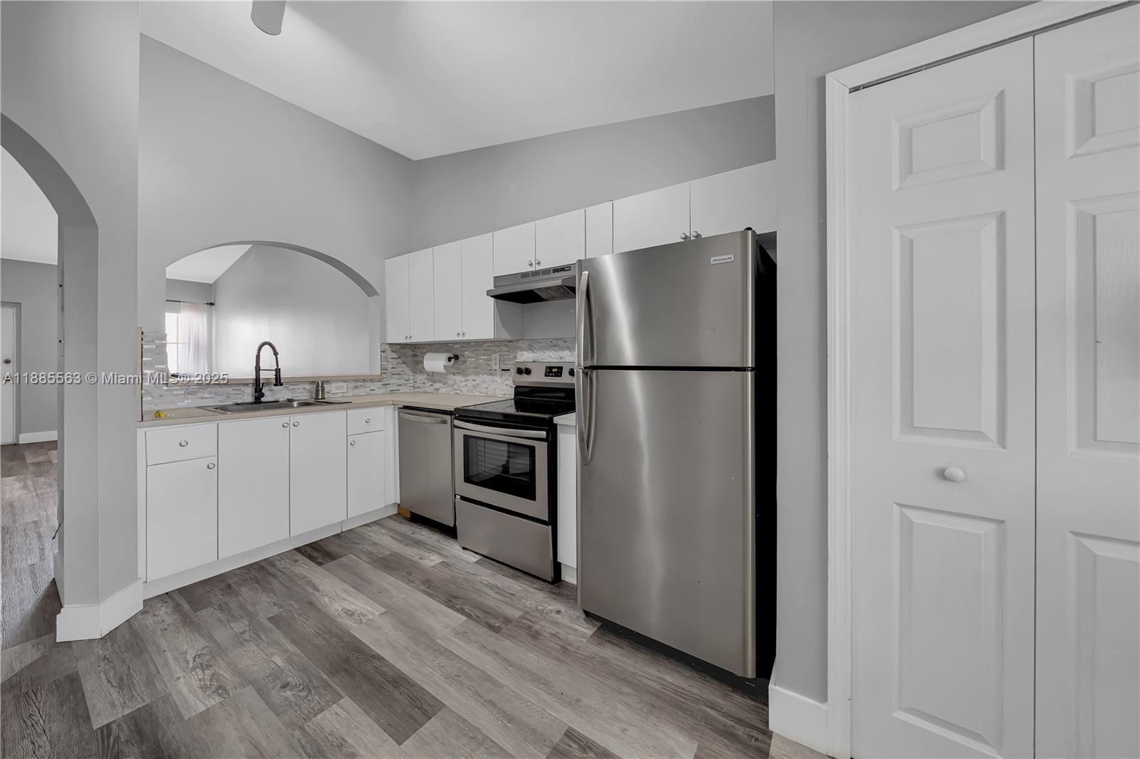 1261 Southeast 27th Street, Unit 203 Homestead, FL 33035 - Photo 10 of 18 a kitchen with a refrigerator sink and cabinets