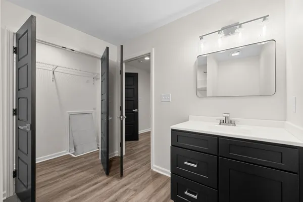 a bathroom with a sink a mirror and shower
