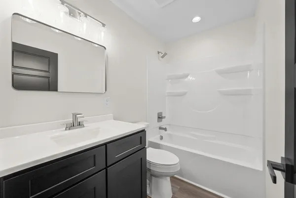 a bathroom with a sink a toilet and bathtub