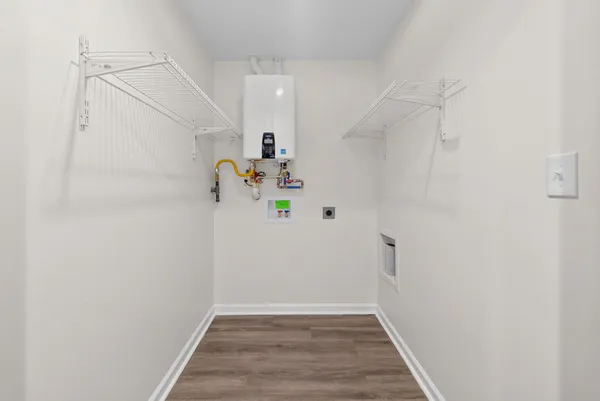 a view of storage and utility room with wooden floor