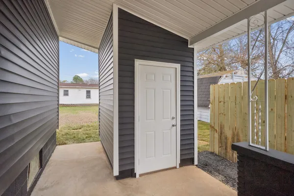 a view of a door and wooden floor in front of house