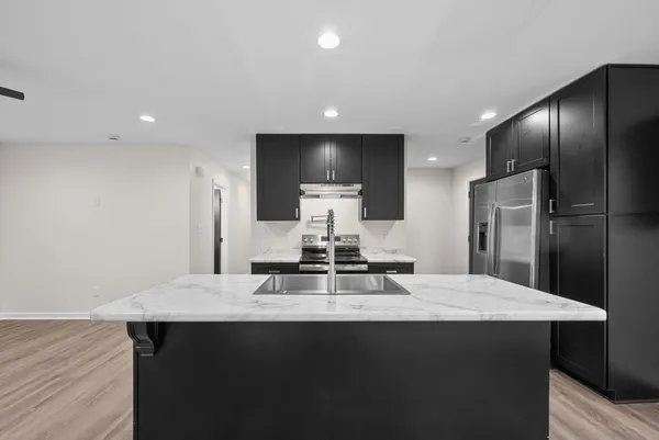 a kitchen with a refrigerator and a sink