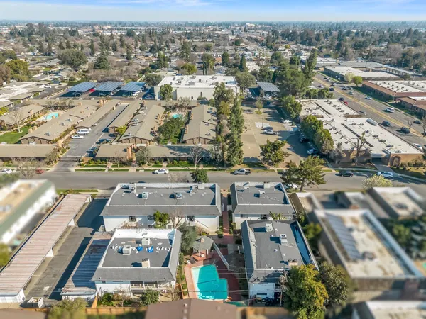 an aerial view of a house with a yard and a fountain