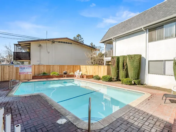 a view of a backyard with a swimming pool