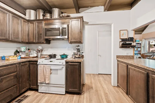 a kitchen with stainless steel appliances granite countertop a stove and a refrigerator
