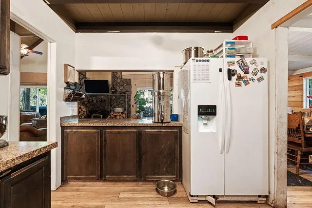 a kitchen with stainless steel appliances granite countertop a refrigerator and a stove