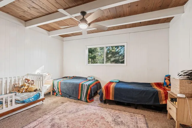 a bedroom with bed and a chandelier