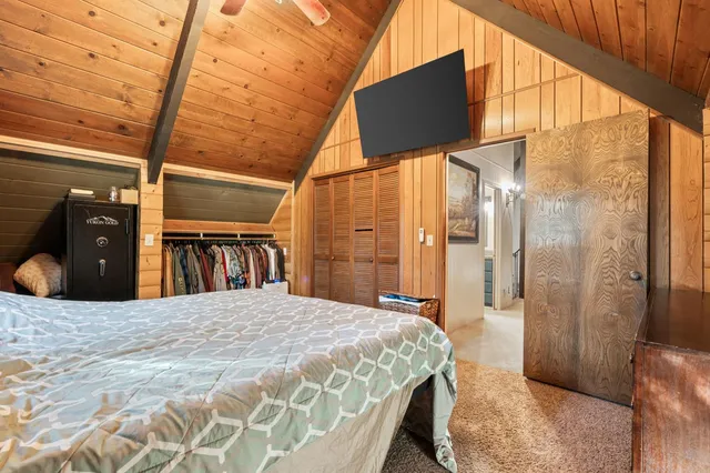 a bedroom with a bed closet and a large window