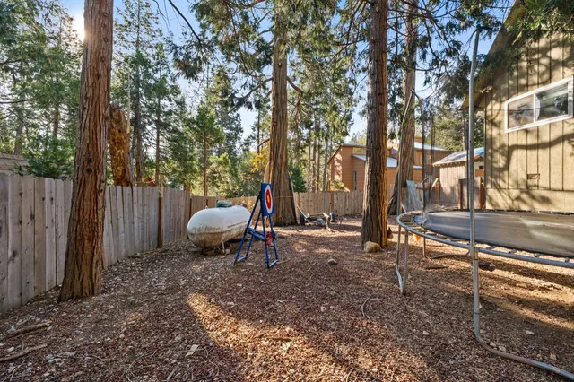 a backyard of a house with table and chairs