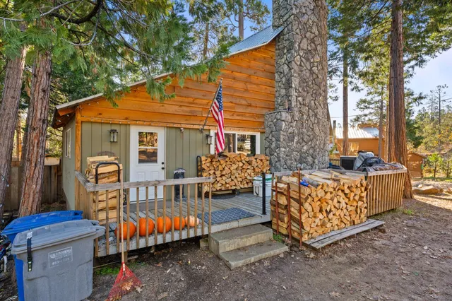 a view of a house with a chairs and table in a patio