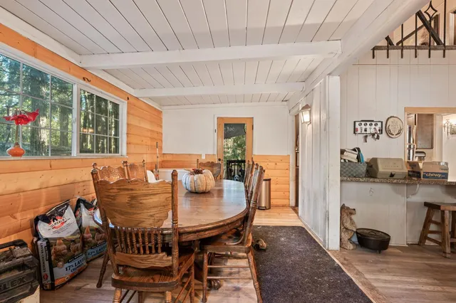 a dining room with furniture and a floor to ceiling window