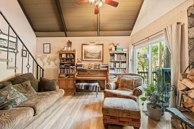 a living room with furniture fireplace and wooden floor