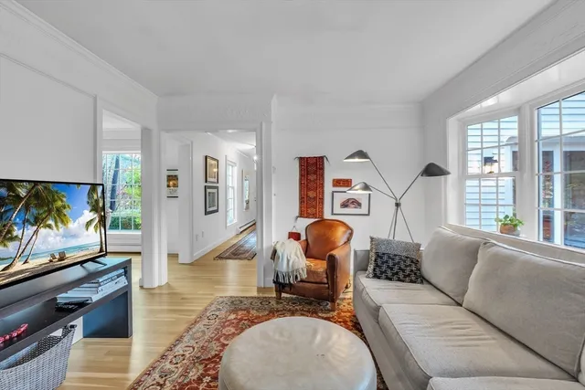 a kitchen with stainless steel appliances granite countertop a refrigerator a sink dishwasher a stove and white countertops with wooden floor