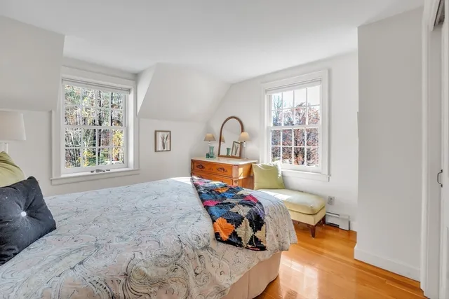 a bedroom with furniture and wooden floor