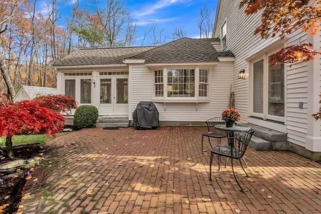 a view of a patio with a table and chairs and potted plants