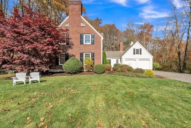 a view of a house with a yard and garage