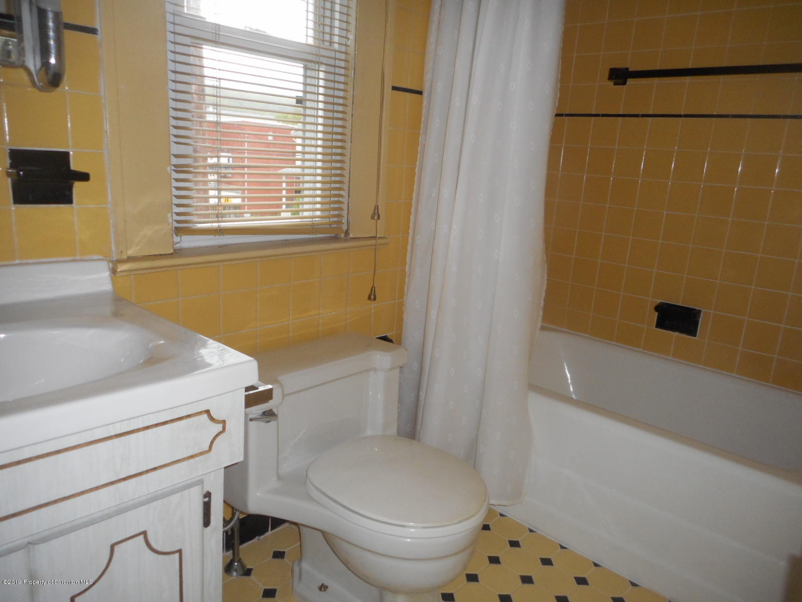 232 Oak Street Old Forge, PA 18518 - Photo 14 of 19 a bathroom with a sink a toilet and shower
