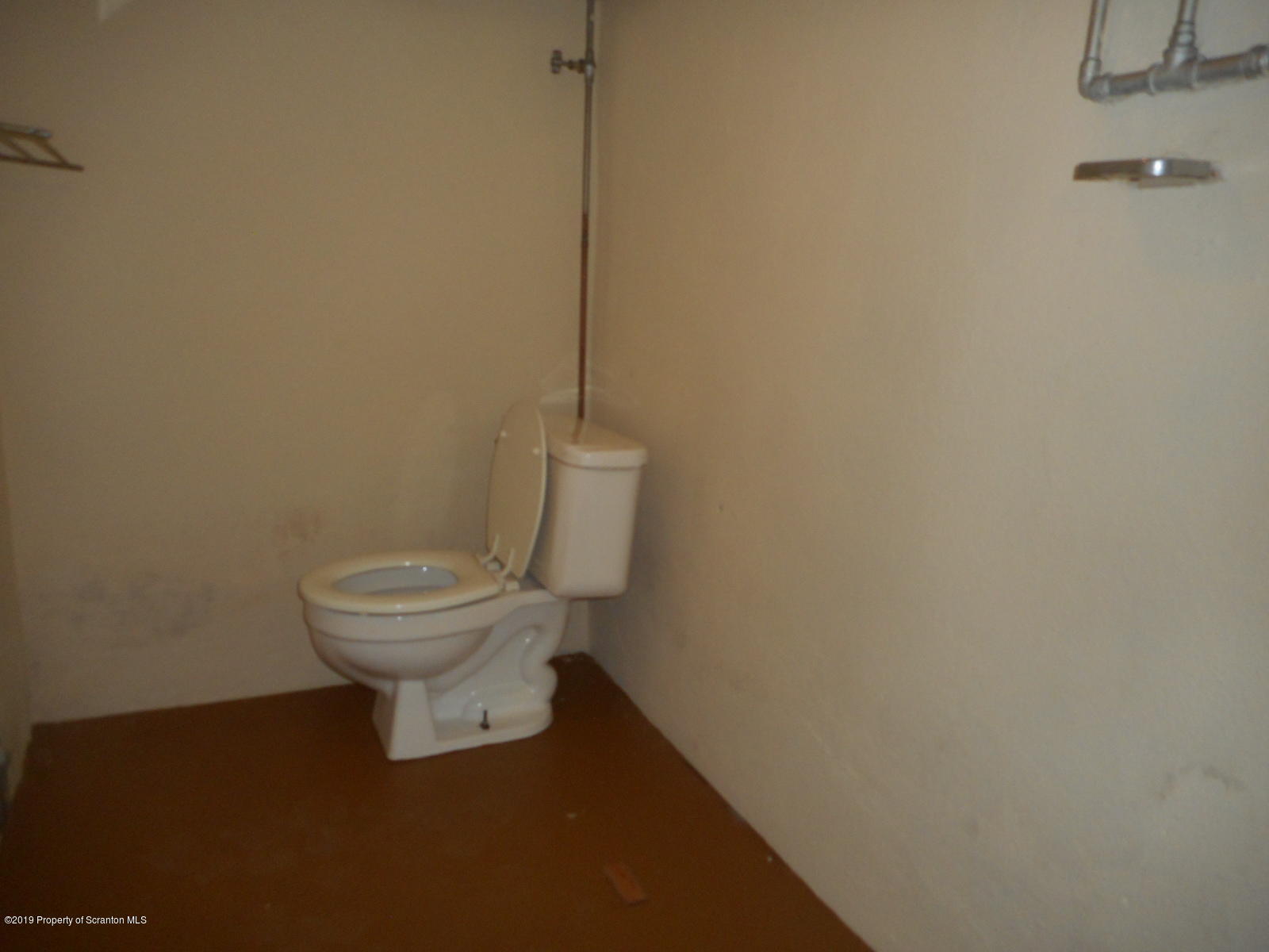 232 Oak Street Old Forge, PA 18518 - Photo 17 of 19 a white toilet sitting next to a shower