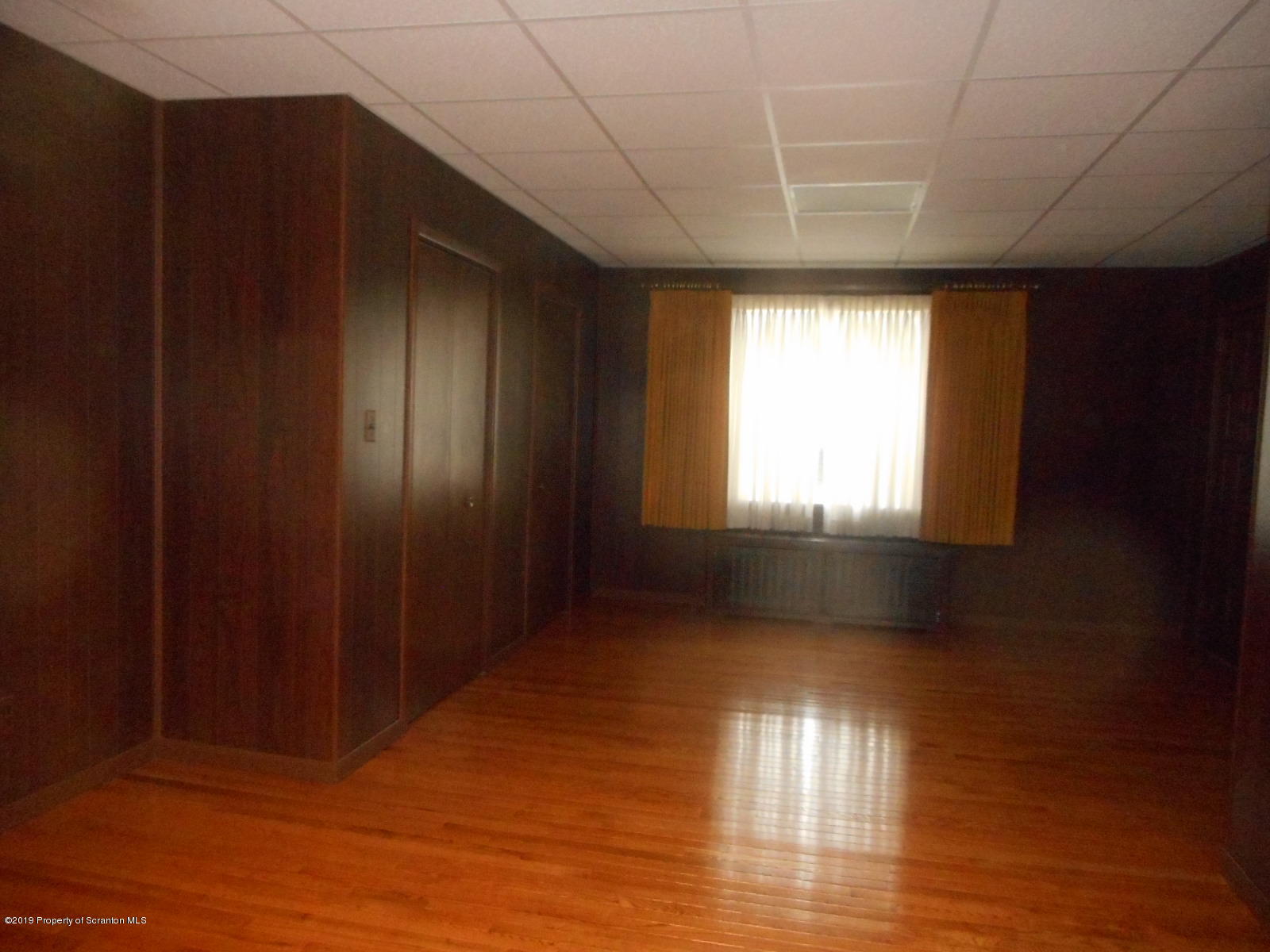 232 Oak Street Old Forge, PA 18518 - Photo 7 of 19 a view of empty room with wooden floor and fan