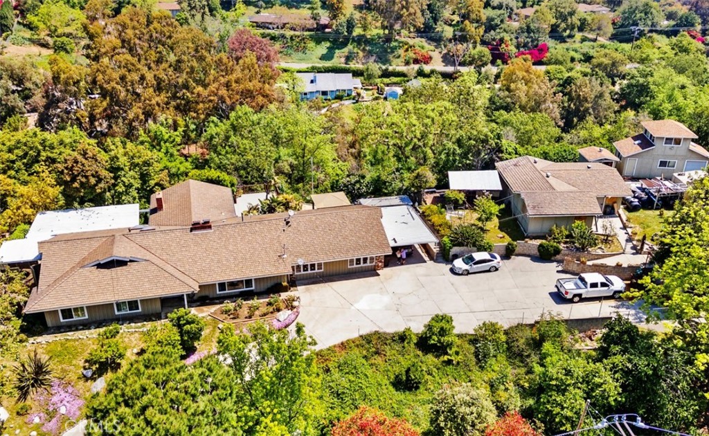 an aerial view of a house with a yard and pool