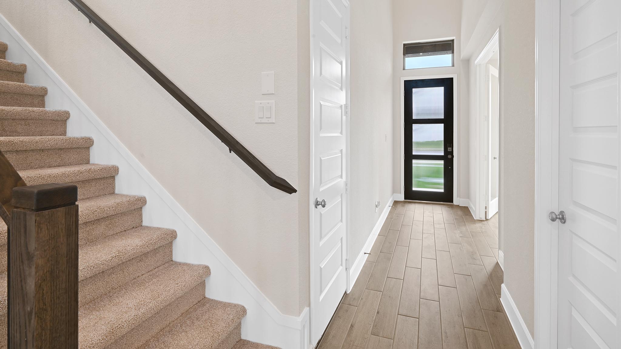 338 Prickly Poppy Loop Kyle, TX 78640 - Photo 13 of 40 Foyer entrance with light wood-style flooring and stairway