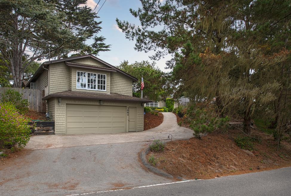 3041 Bird Rock Road Pebble Beach, CA 93953 - Photo 2 of 18 a front view of a house with a yard
