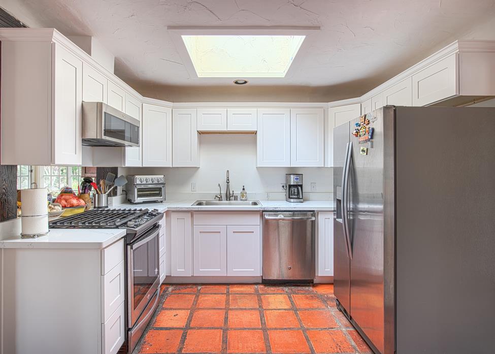 3041 Bird Rock Road Pebble Beach, CA 93953 - Photo 8 of 18 a kitchen with stainless steel appliances granite countertop a refrigerator sink and stove