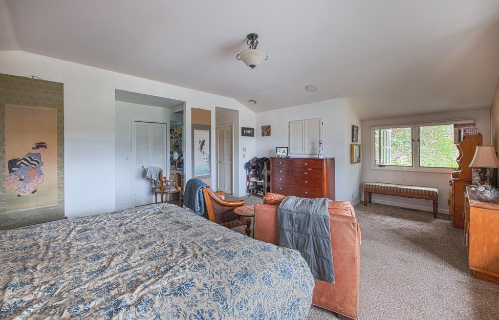 3041 Bird Rock Road Pebble Beach, CA 93953 - Photo 10 of 18 a bedroom with a bed and wooden floor