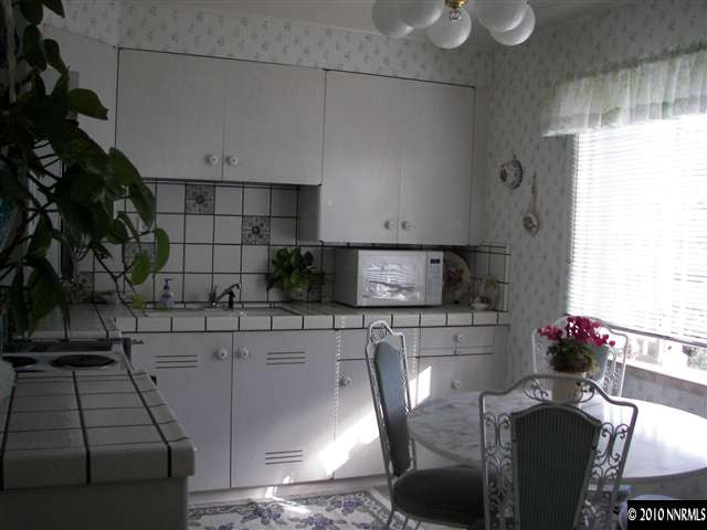200 Bisby Street Reno, NV 89512 - Photo 5 of 13 a kitchen with stainless steel appliances kitchen island granite countertop a sink and a stove