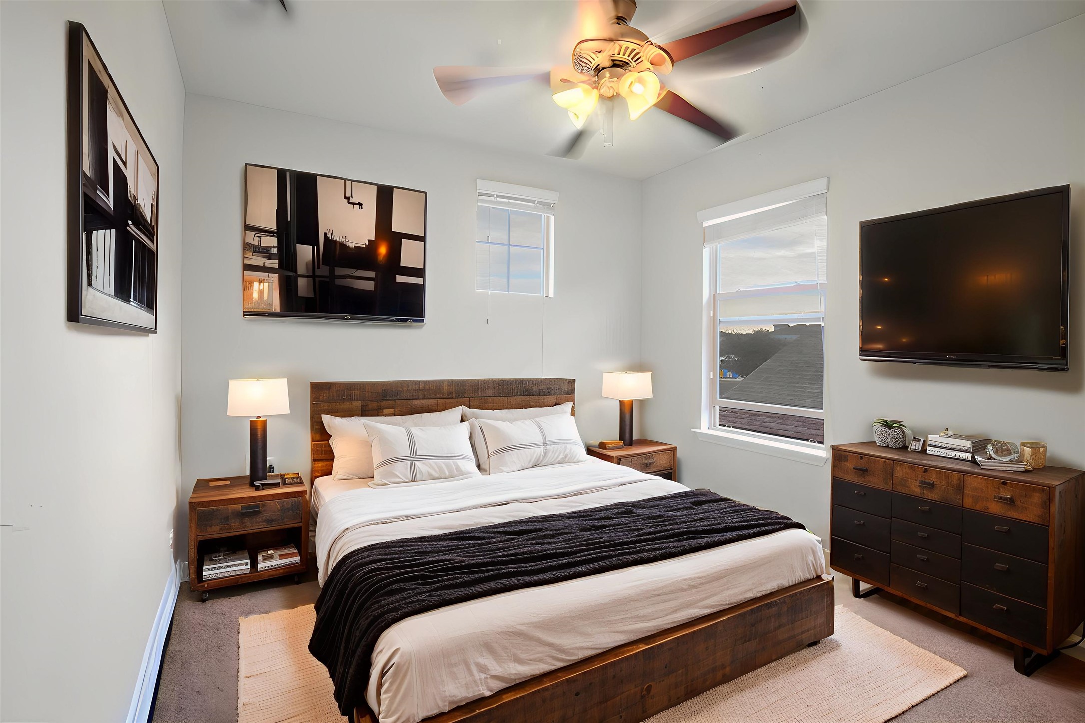 16012 McAloon Way Austin, TX 78728 - Photo 23 of 34 a bedroom with a bed a flat screen tv and a chandelier