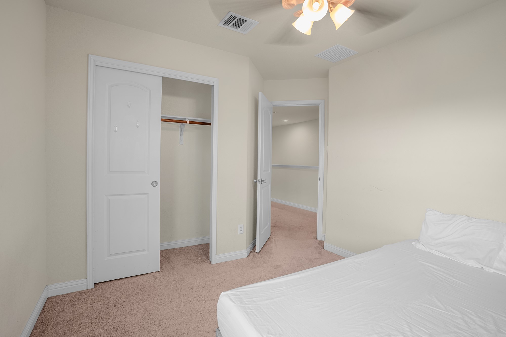 16012 McAloon Way Austin, TX 78728 - Photo 25 of 34 a bedroom with a bed and a chandelier fan